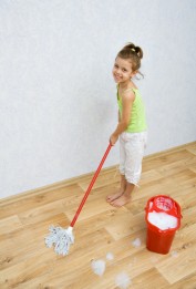 Little girl cleaning the floor