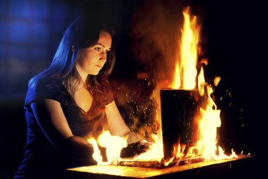 Woman uses a burning laptop